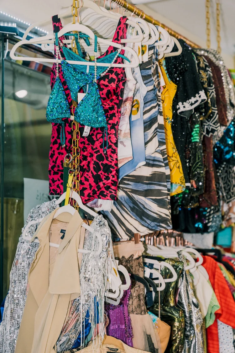 Colorful dresses and clothing arranged on hangers at Quirk.